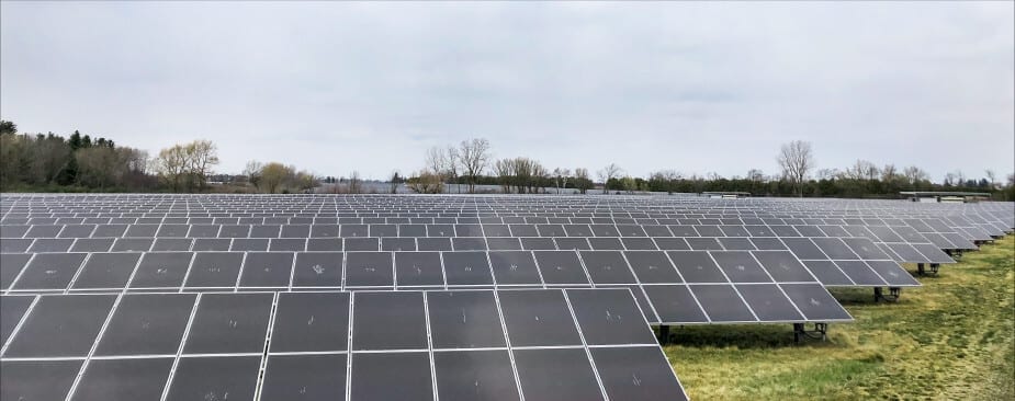 A picture of a field of solar panels installed on the ground